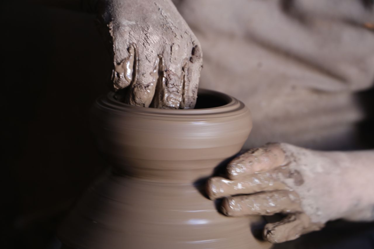 Master artisan handcrafting Yixing Zisha teapot in traditional workshop